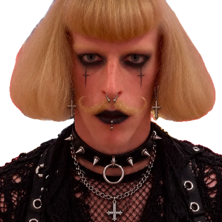 Jean Goth: blonde blunt bob with a heavy fringe, curled moustache, black lips, cross earrings and a spiked collar